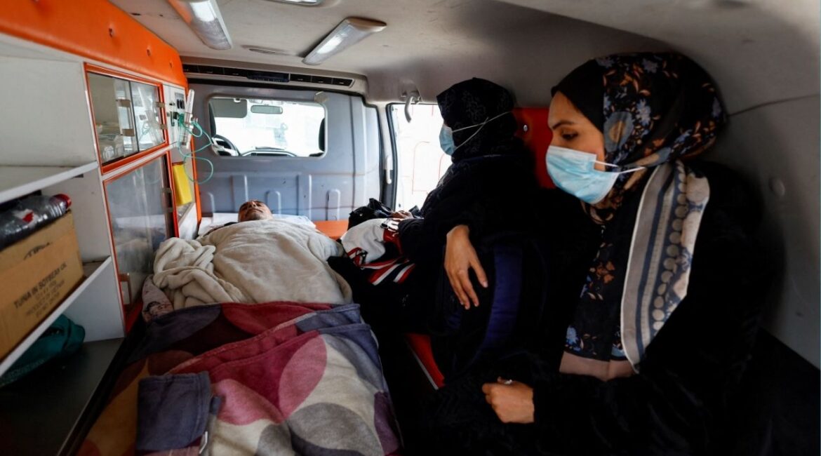 A Palestinian patient lies inside an ambulance, accompanied by relatives, as they make their way back to their homes after being informed by officials that their travel scheduled for today through the Rafah border crossing was postponed, in Khan Younis in the southern Gaza Strip, February 4, 2026. (Reuters/Mahmoud Issa)