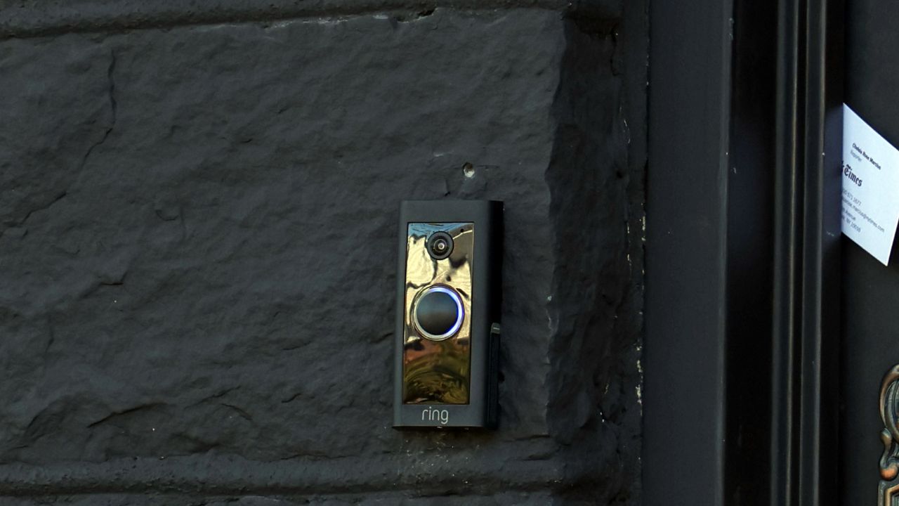A Ring doorbell/security camera on the front of the house in Queens on Oct. 16, 2025. Ring created a Super Bowl commercial around the tale of a lost dog being reunited with his family through information harvested from a web of doorbell cameras. After much criticism that the commercial felt more invasive than heartwarming, Ring said it was ending a recent partnership with a surveillance technology firm. (Jefferson Siege/The New York Times)