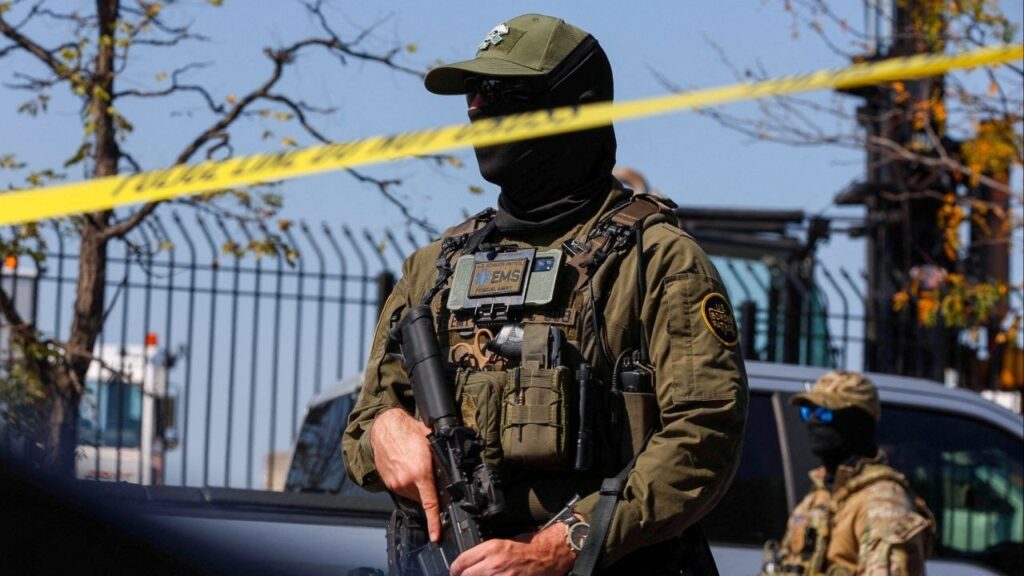 A U.S. Border Patrol officer stands behind tape during demonstrators' standoff with U.S. Immigration and Customs Enforcement (ICE) and federal officers in the Little Village neighborhood of Chicago, Illinois, U.S., October 4, 2025. (Reuters File)