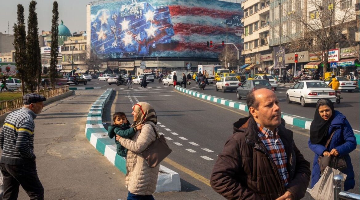 A billboard threatening action against American warships in Enghelab Square in Tehran, on Tuesday, Jan. 27, 2026. The president of Iran, Masoud Pezeshkian, said on Tuesday that he supported “fair and equitable negotiations” with the United States, as regional diplomats work to de-escalate tensions between the two countries. (Arash Khamooshi/The New York Times)