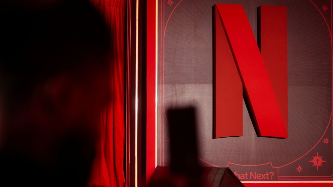 A man takes a photograph next to a Netflix logo during an event in Mumbai, India, February 3, 2026. (Reuters/Francis Mascarenhas)
