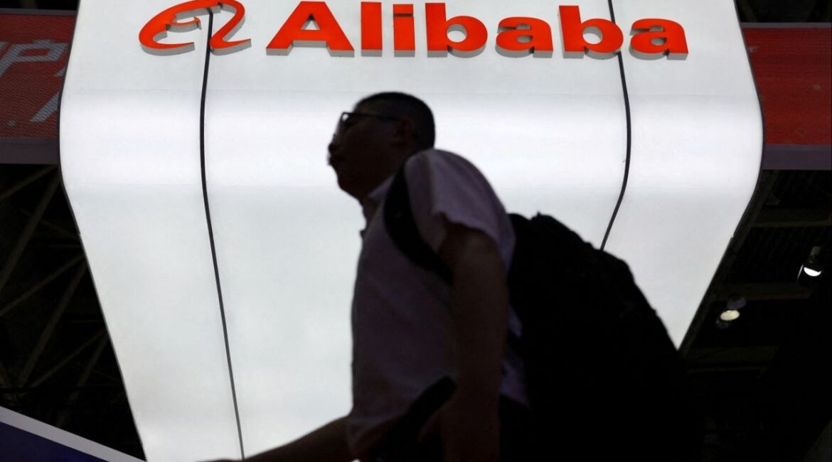 A man walks past the Alibaba logo displayed at its booth during the China International Supply Chain Expo in Beijing, China July 16, 2025. (Reuters File)