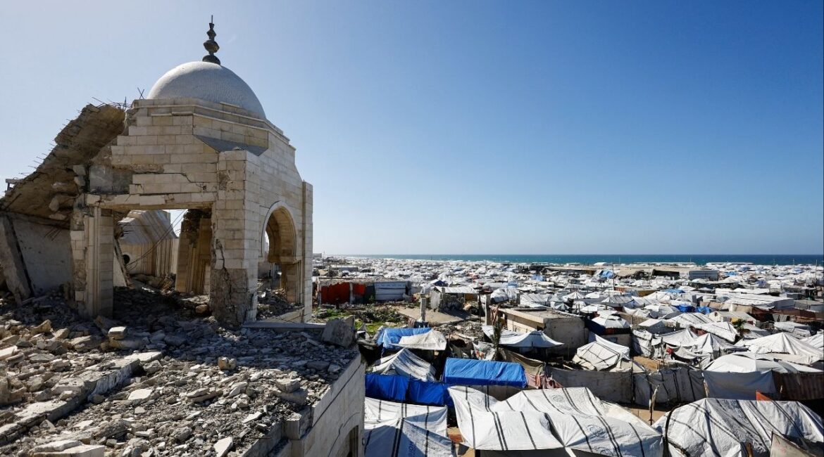 A mosque, destroyed during the two-year Israeli offensives, is surrounded by tents for displaced Palestinians, in Gaza City, February 11, 2026. (Reuters/Mahmoud Issa)