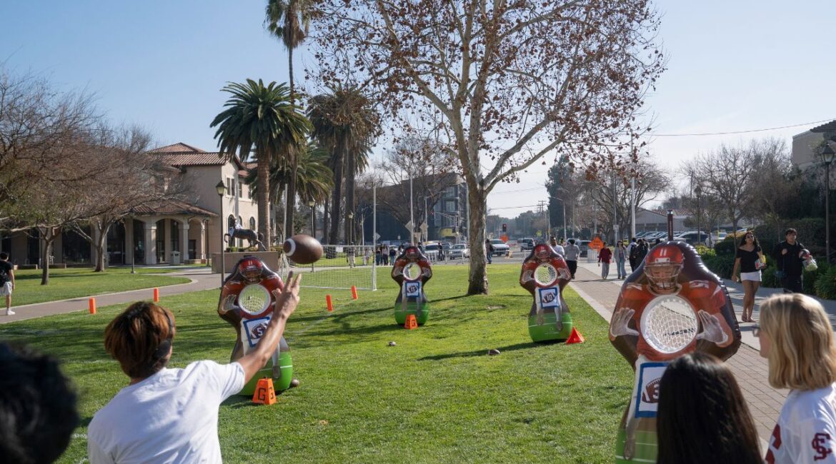 A student throws a football at passing targets during Super Bowl-themed activities on the campus in Santa Clara, Calif., Feb. 5, 2026. Media and internet mentions of Sunday’s Super Bowl LX almost always place the game in San Francisco, but the hosting Levi’s Stadium , home of the 49ers, is actually 45 miles to the south in the suburban Silicon Valley city of Santa Clara, Calif., adjacent to San Jose. (Minh Connors/The New York Times)