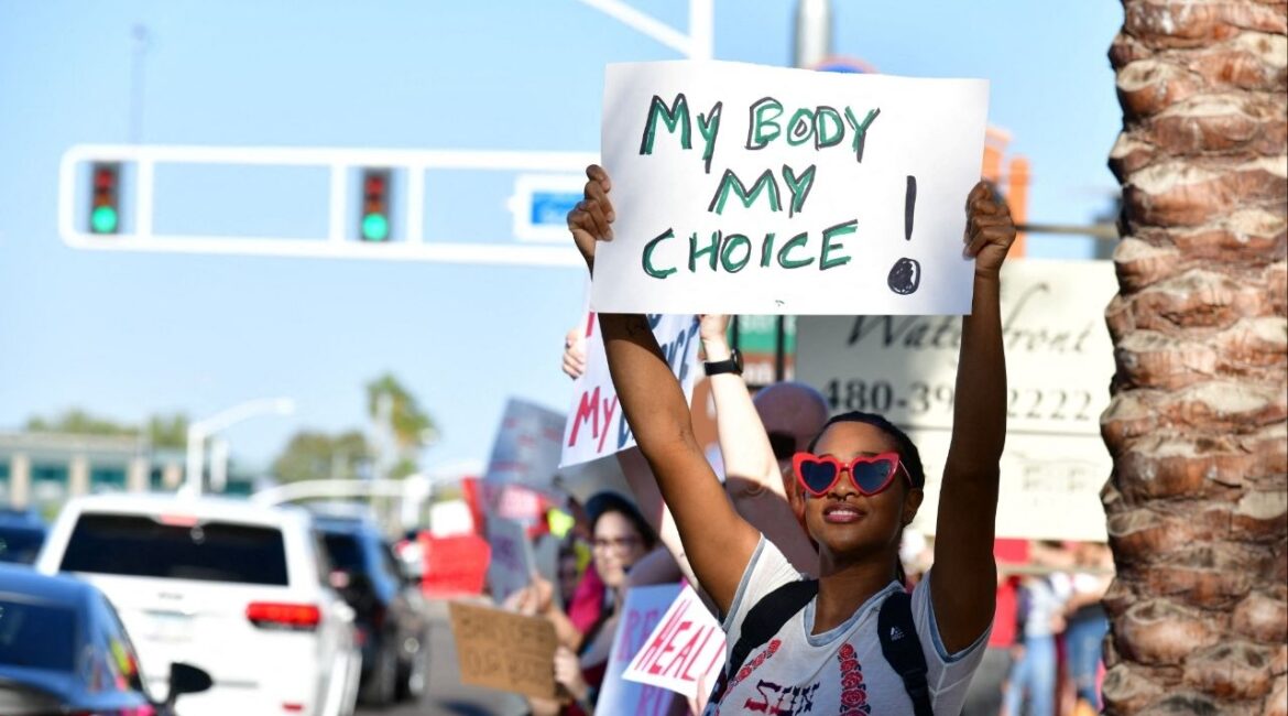 A woman holds a sign at a protest in the district of Republican state Representative Matt Gress after Arizona's Supreme Court revived a law dating to 1864 that bans abortion in virtually all instances, in Scottsdale, Arizona, U.S. April 14, 2024. (Reuters/Caitlin O’Hara)