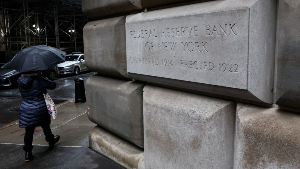 A woman passes by The Federal Reserve Bank of New York in New York City, U.S., March 13, 2023. (Reuters File)