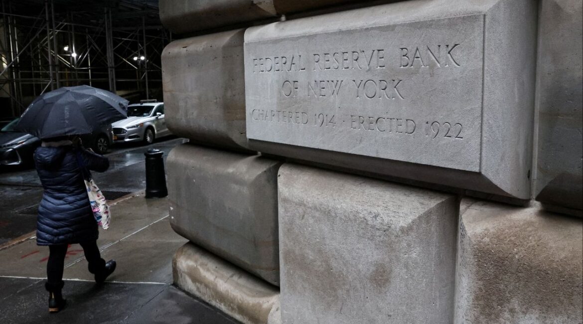A woman passes by The Federal Reserve Bank of New York in New York City, U.S., March 13, 2023. (Reuters File)