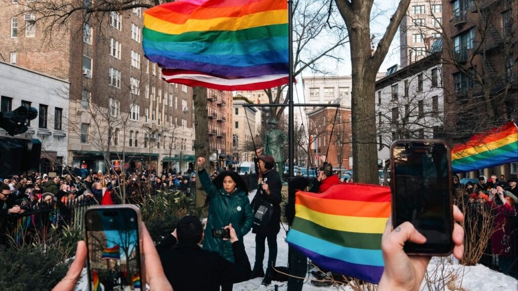 Activists add a Pride flag to the flagpole at Stonewall National Monument, where one previously flew before the Trump administration had it removed, in Manhattan’s Greenwich Village neighborhood, Feb. 12, 2026. A group of nonprofits filed a lawsuit in federal court on Tuesday, Feb. 17, 2026, against the Trump administration, arguing that its decision to remove the Pride flag from the Stonewall National Monument in Manhattan this month violated a federal law that allows national parks and monuments to fly Confederate flags. (Cristina Matuozzi/The New York Times)