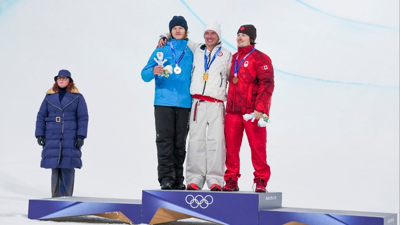 Alex Ferreira of the U.S. celebrates winning gold, joined by silver medalist Henry Sildaru of Estonia, left, and bronze medalist Brendan Mackay of Canada, right in the freestyle men’s freeski halfpipe final, during the 2026 Milan Cortina Winter Olympics in Livigno, Italy, on Friday, Feb. 20, 2026. (Gabriela Bhaskar/The New York Times)