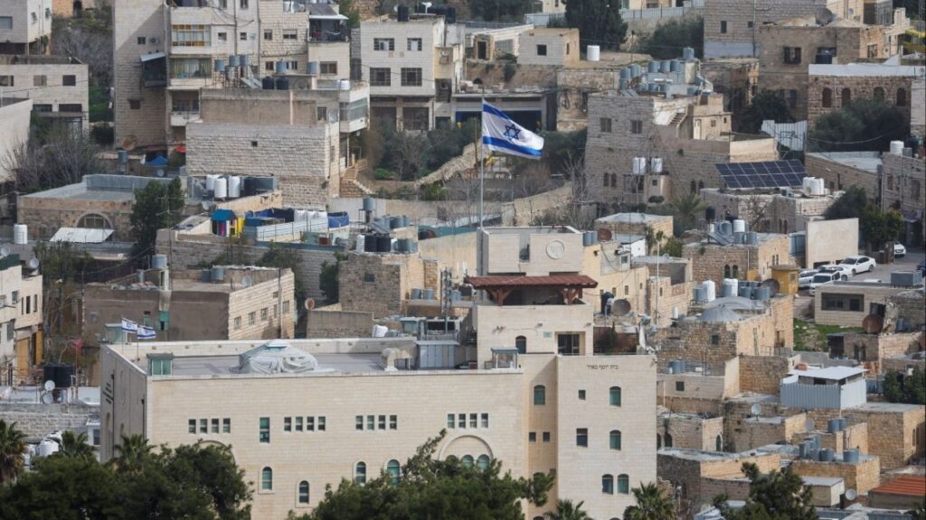 An Israeli flag flies over an Israeli settlement in the old city in Hebron in the Israeli-occupied West Bank, February 9, 2026. (Reuters/Mussa Qawasma)