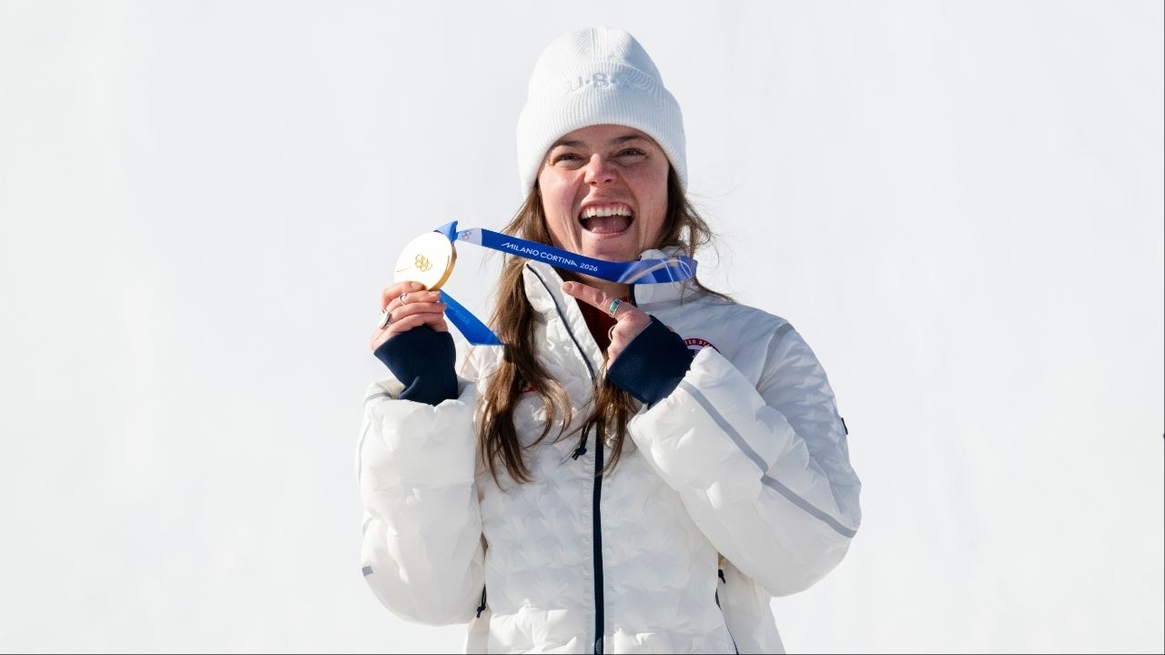 Breezy Johnson of the United States reacts on the podium after winning gold in the women’s downhill during the 2026 Milan Cortina Winter Olympics in Cortina d’Ampezzo, Italy, Feb. 8, 2026. Several athletes have had their medals fall off their ribbons while celebrating their victories. Organizers are looking into it: “This is something we want to be perfect.” (James Hill/The New York Times)