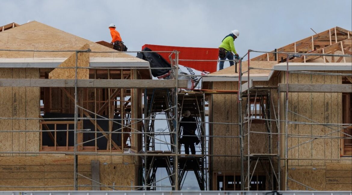 Construction workers use wood and lumber to build residential homes in Irvine, California, U.S., March 28, 2025. (Reuters/Mike Blake)