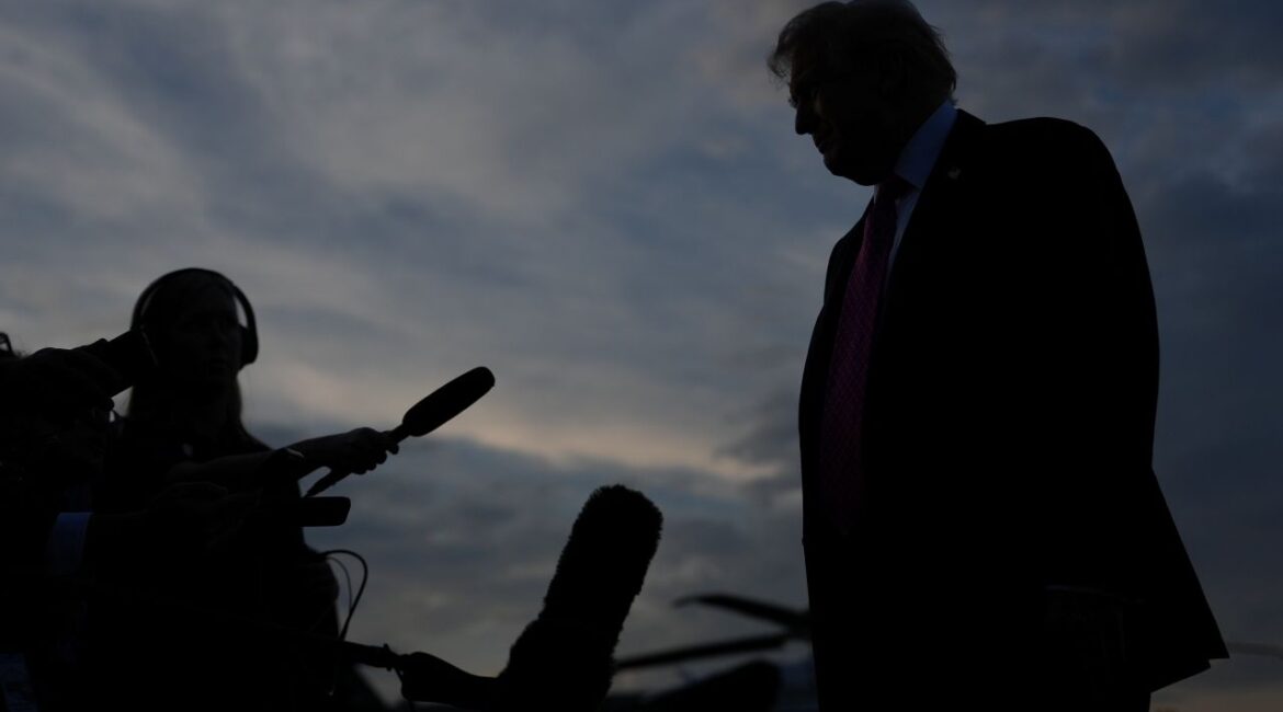 Silhouette image of Donald Trump talking to reporters