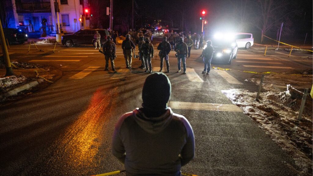 Federal agents face off with protestors in a neighborhood after a federal agent shot a man from Venezuela while attempting to detain him in Minneapolis, Jan. 14, 2026. The top federal prosecutor in Minnesota acknowledged on Thursday, Feb. 12, that officials had provided incorrect information about a shooting by an immigration agent last month. (David Guttenfelder/ The New York Times)