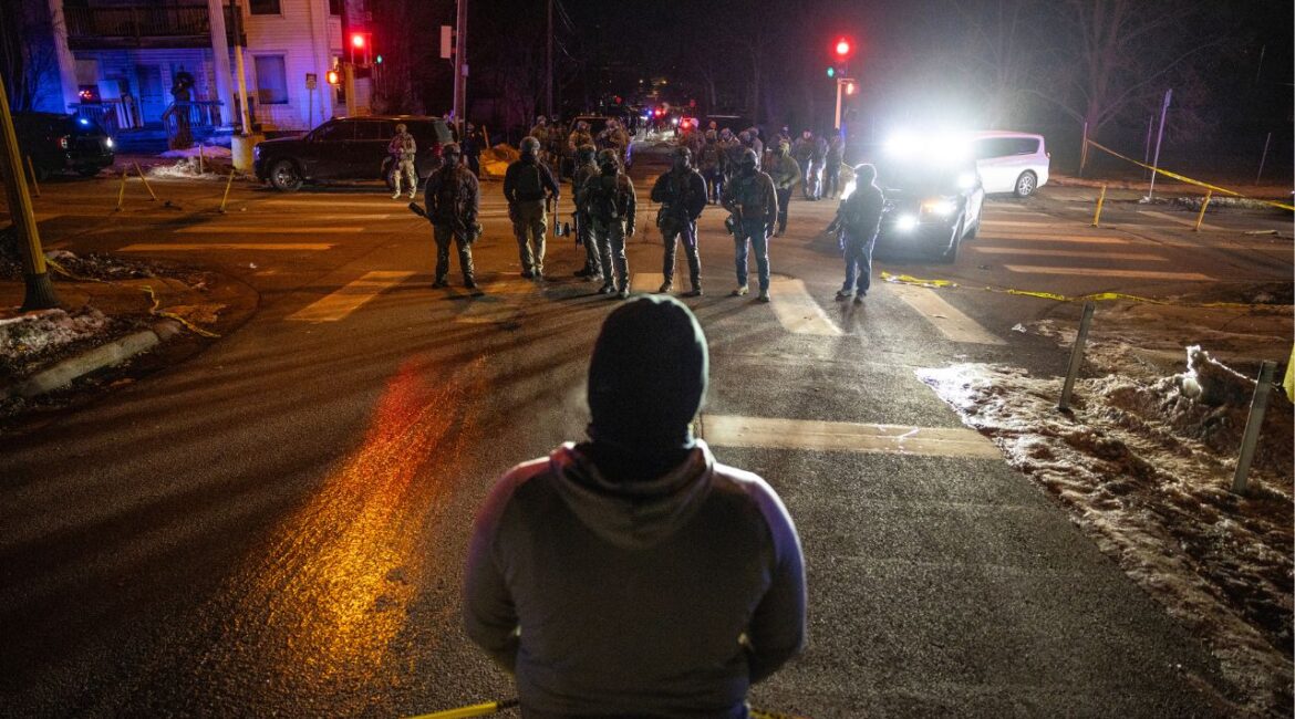 Federal agents face off with protestors in a neighborhood after a federal agent shot a man from Venezuela while attempting to detain him in Minneapolis, Jan. 14, 2026. The top federal prosecutor in Minnesota acknowledged on Thursday, Feb. 12, that officials had provided incorrect information about a shooting by an immigration agent last month. (David Guttenfelder/ The New York Times)