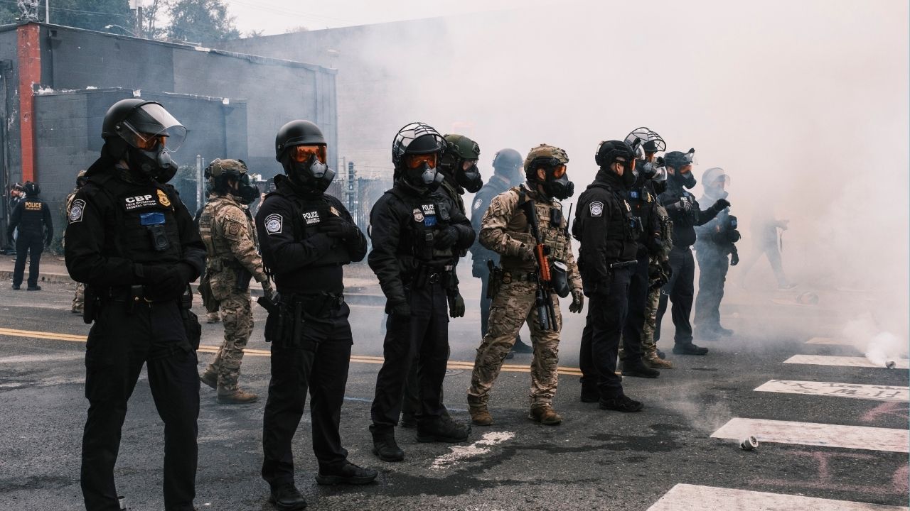 Federal agents faced off with protesters outside a federal detention center in Portland, Ore., Oct. 18, 2025. The tear-gassing this weekend in Portland, Ore., of a protest billed as “family friendly” has prompted Portland’s mayor and City Council to consider dramatic new steps, including financial penalties, to try to force Immigration and Customs Enforcement out of the city. (Jordan Gale/The New York Times)