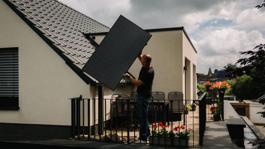 Heiko Billen looks for the best place to install a solar panel on the balcony of his home in Dusseldorf, Germany, July 10,2024. As the Trump administration stymies hundreds of commercial solar and wind projects nationwide, legislators in 24 states want to literally put the power in the hands of the people by allowing modest solar enegry systems on balconies, porches and backyards. (Patrick Junker/ The New York Times)