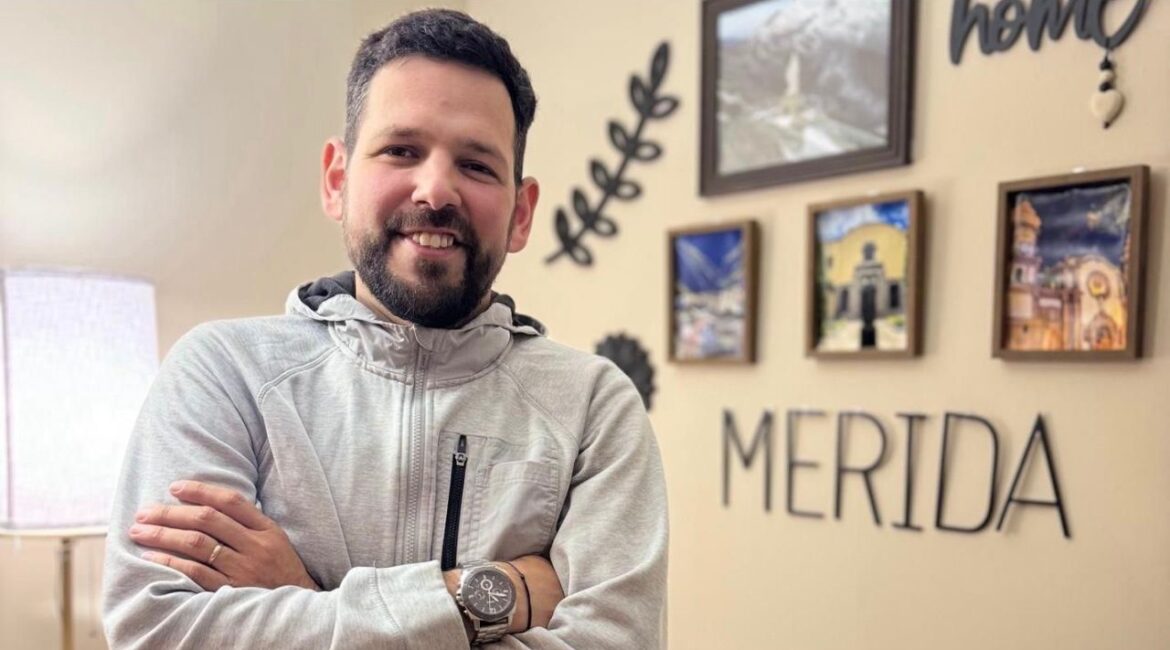 In a photo provided by family, Carlos Roberto Garcia at home in Cincinnati with moments from his Venezuelan hometown, Merida, where he was elected mayor. Garcia, who opposed the Maduro regime, fled Venezuela in 2017, claimed asylum in America, and built a new life as a delivery driver in Cincinnati. He now faces deportation back to a country with a long history of punishing political dissents. (Family photo via The New York Times)