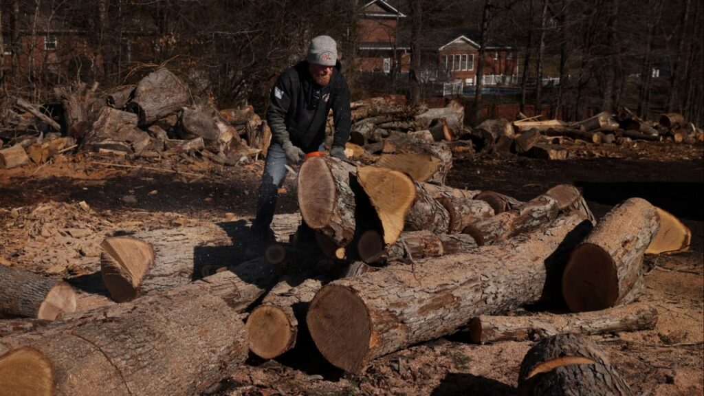 Jason Loflin prepares firewood for customers at one of his lots in Thomasville, N.C., where demand was high enough recently that he recruited friends from his gym for help, on Feb. 13, 2026. Weeks of freezing temperatures and winter storms across parts of the United States have increased the demand for firewood and manufactured fire logs. (Travis Dove/The New York Times)