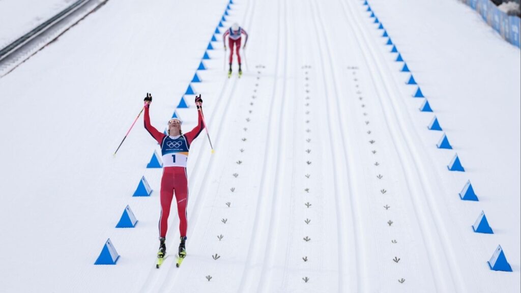 Johannes Hoesflot Klaebo (1), of Norway, crosses the finish line first and winning gold during the 50km mass start cross-country skiing men's competition at the 2026 Milan Cortina Winter Olympics in Lago, Italy, Saturday, Feb. 21, 2026. (Vincent Alban/The New York Times)