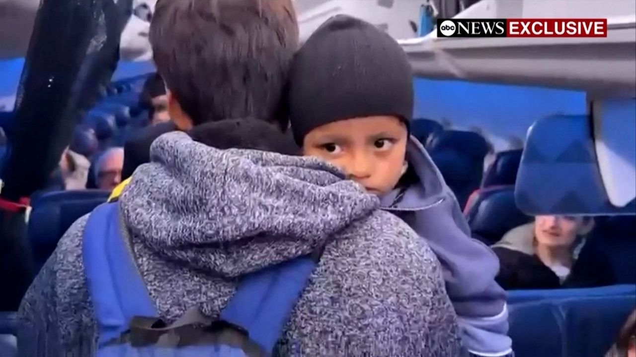Liam Conejo Ramos is held by his father Adrian Alexander Conejo Arias while boarding an aircraft to return to Minneapolis, after the pair who had been detained by immigration officers were ordered released by a judge from a Texas detention center, in San Antonio, Texas, U.S., February 1, 2026 in a still image from video. (ABC News via Reuters)