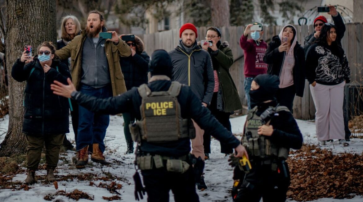 Image of Minneapolis residents videoing and protesting the presence of masked ICE agents