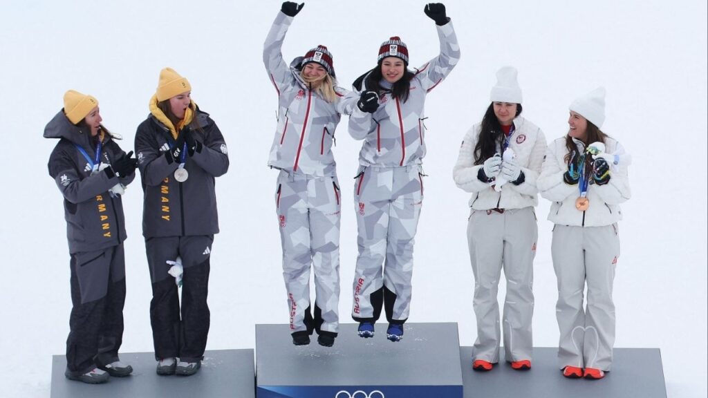 Milano Cortina 2026 Olympics - Alpine Skiing - Women's Team Combined Victory Ceremony - Tofane Alpine Skiing Centre, Belluno, Italy - February 10, 2026. Gold medallists Ariane Raedler of Austria and Katharina Huber of Austria celebrate on the podium after winning the Women's Team Combined with silver medallists Kira Weidle-Winkelmann of Germany and Emma Aicher of Germany and bronze medallists Jacqueline Wiles of United States and Paula Moltzan of United States. (Reuters/Leonhard Foeger)