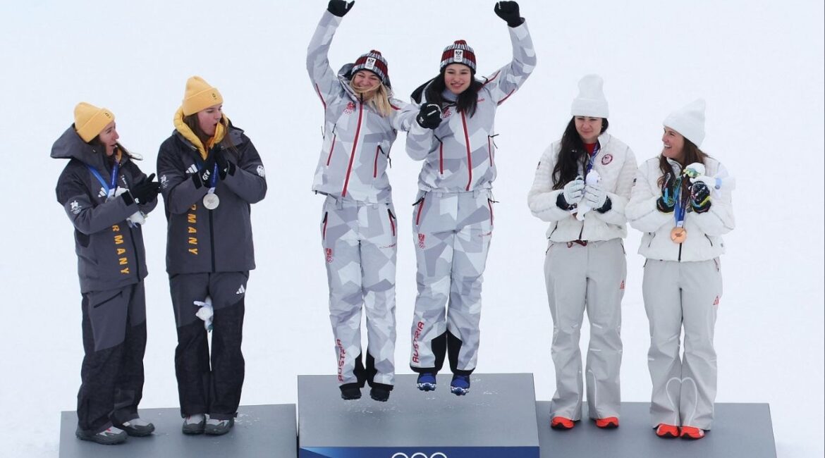 Milano Cortina 2026 Olympics - Alpine Skiing - Women's Team Combined Victory Ceremony - Tofane Alpine Skiing Centre, Belluno, Italy - February 10, 2026. Gold medallists Ariane Raedler of Austria and Katharina Huber of Austria celebrate on the podium after winning the Women's Team Combined with silver medallists Kira Weidle-Winkelmann of Germany and Emma Aicher of Germany and bronze medallists Jacqueline Wiles of United States and Paula Moltzan of United States. (Reuters/Leonhard Foeger)