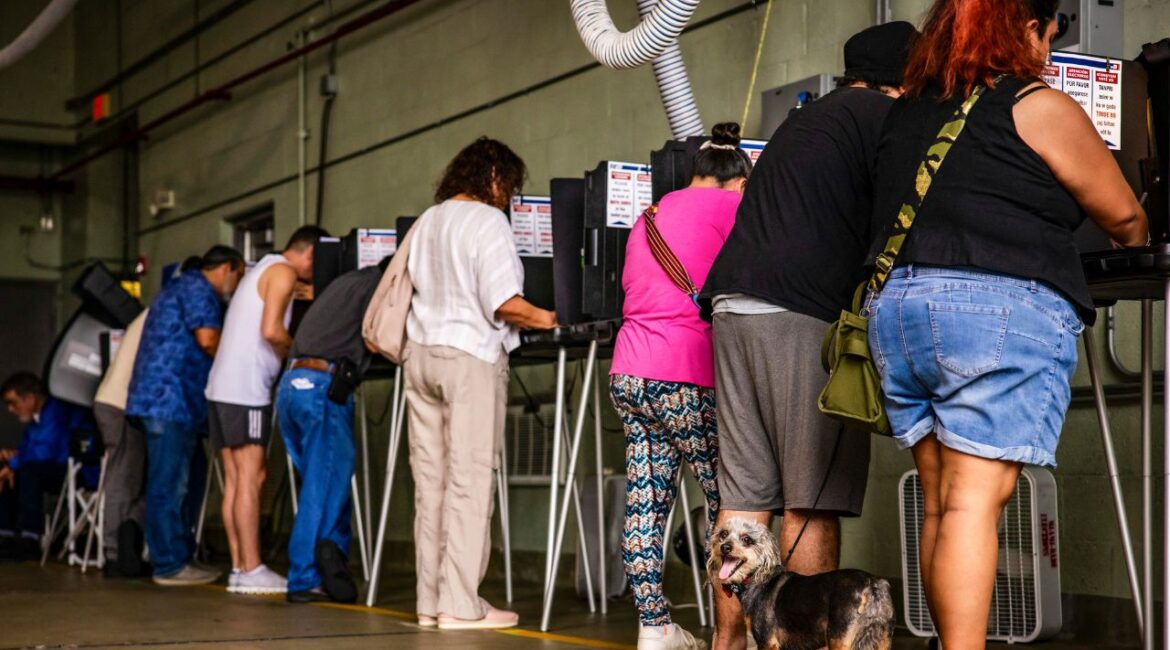 People cast their ballots at a polling location inside a Miami Beach Fire Department firehouse in Miami Beach, Fla., Nov. 5, 2024. A new nationwide effort by the Trump administration to find and charge criminal voting cases appears to be targeted at green card holders. (Scott McIntyre/ The New York Times)