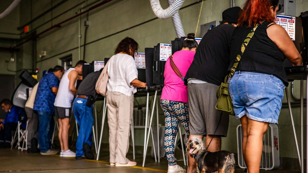 People cast their ballots at a polling location inside a Miami Beach Fire Department firehouse in Miami Beach, Fla., Nov. 5, 2024. A new nationwide effort by the Trump administration to find and charge criminal voting cases appears to be targeted at green card holders. (Scott McIntyre/ The New York Times)