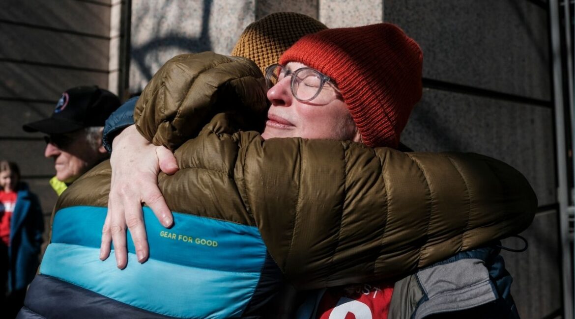 People exchange a hug as former employees of The Washington Post and supporters rally outside of the company’s offices in Washington, on Thursday, Feb. 5, 2026. The Washington Post carried out a widespread round of layoffs on Wednesday that decimated the organization’s sports, local news and international coverage. (Michael A. McCoy/The New York Times)