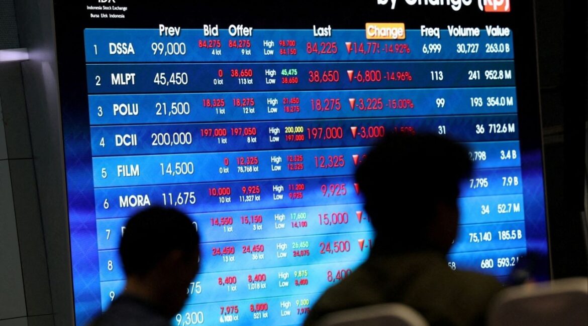 People sit near an electronic board showing stock market index at the Indonesia Stock Exchange (IDX) in Jakarta, Indonesia, February 2, 2026. (Reuters File)