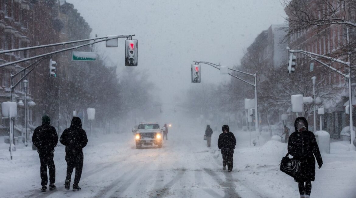 People walk in local street covered with snow during a winter storm in Hoboken, New Jersey, U.S., February 23, 2026. (Reuters/Eduardo Munoz)