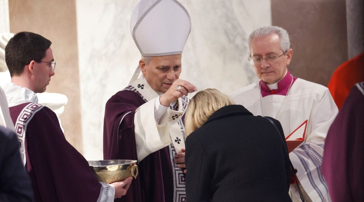 Pope Leo XIV puts ash on a faithful's head during the Ash Wednesday Mass at the Santa Sabina Basilica in Rome, Italy, February 18, 2026. (Reuters/Remo Casilli)