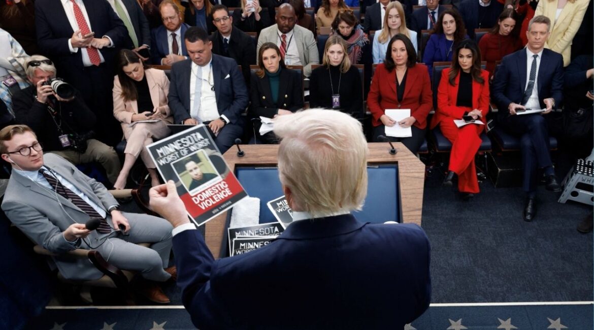 President Donald Trump holds images of alleged criminals taken off the street by ICE as he speaks during a press briefing at the White House, on the one-year mark into his second term in office, in Washington, D.C., U.S., January 20, 2026. (Reuters/Jessica Koscielniak)