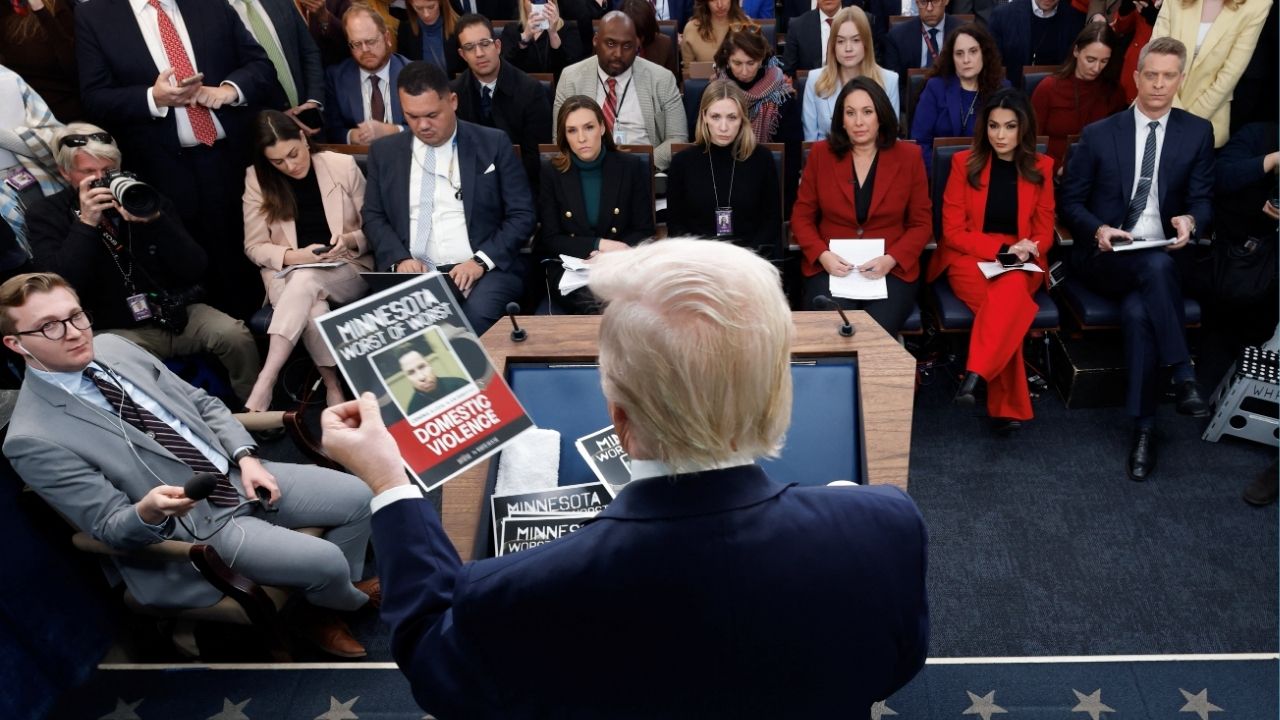 President Donald Trump holds images of alleged criminals taken off the street by ICE as he speaks during a press briefing at the White House, on the one-year mark into his second term in office, in Washington, D.C., U.S., January 20, 2026. (Reuters/Jessica Koscielniak)