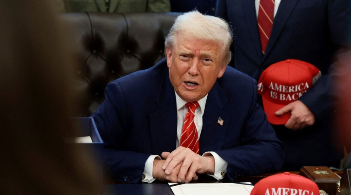 President Donald Trump sits behind a bill he signed to end the partial government shutdown, at the White House in Washington, D.C., U.S., February 3, 2026. (Reuters File)