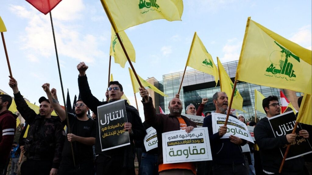 Protesters hold placards and Hezbollah flags during a demonstration condemning recent Israeli military actions in Lebanon, in Beirut, Lebanon February 4, 2026. (Reuters/Mohamed Azakir)