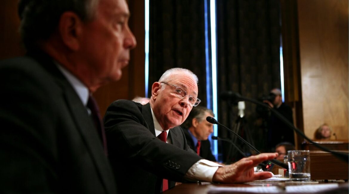 Rep. Lee Hamilton (D-Ind.), chairman of the 9/11 Commission, speaks during a hearing on Capitol Hill in Washington, Jan. 9, 2007. New York Mayor Michael Bloomberg is at left. Hamilton, a former Democratic congressman from rural Indiana who became a major voice in foreign policy during the Iran-Contra affair in the 1980s and in national security investigations after the terrorist attacks of 2001, died on Tuesday, Feb. 3, 2026, at his home in Bloomington, Ind. He was 94. (Doug Mills/The New York Times)