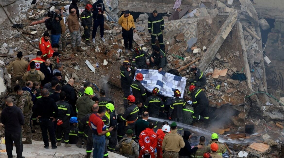 Rescue workers remove a body from under the rubble after a residential building collapsed in Tripoli, Lebanon, February 9, 2026. (Reuters/Mohammed Azakir)