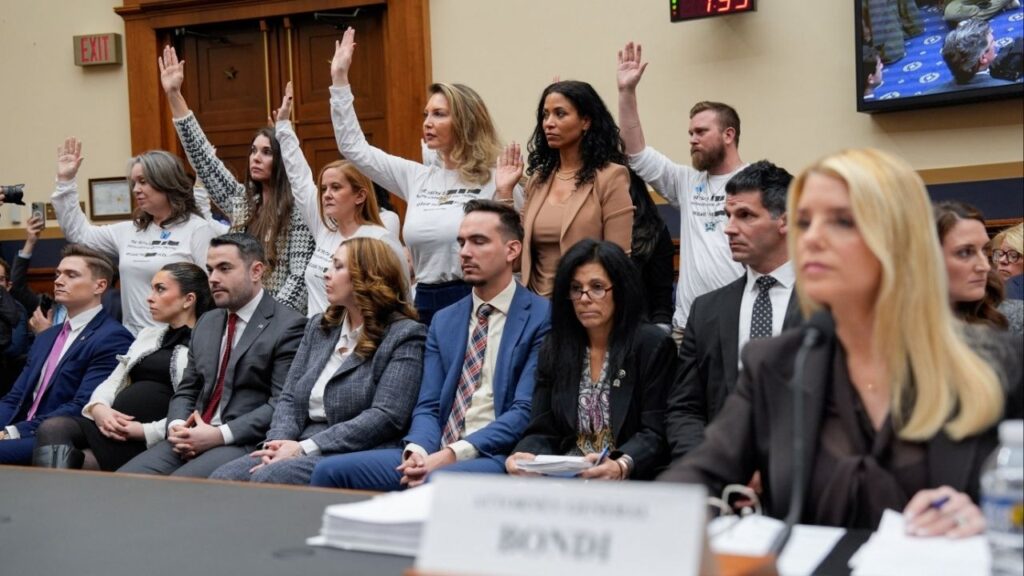 Survivors of Jeffrey Epstein raise their hands after U.S. Representative Pramila Jayapal (D-WA) asked who of them has been unable to meet with the U.S. Department of Justice led by Attorney General Pam Bondi, as Bondi attends a House Judiciary Committee hearing on oversight of the Justice Department to testify, on Capitol Hill in Washington, D.C., U.S., February 11, 2026. (Reuters/Kent Nishimura)