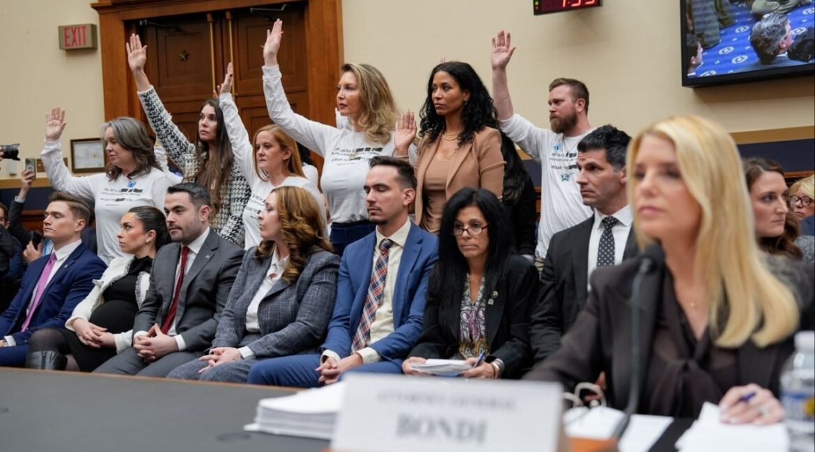 Survivors of Jeffrey Epstein raise their hands after U.S. Representative Pramila Jayapal (D-WA) asked who of them has been unable to meet with the U.S. Department of Justice led by Attorney General Pam Bondi, as Bondi attends a House Judiciary Committee hearing on oversight of the Justice Department to testify, on Capitol Hill in Washington, D.C., U.S., February 11, 2026. (Reuters/Kent Nishimura)