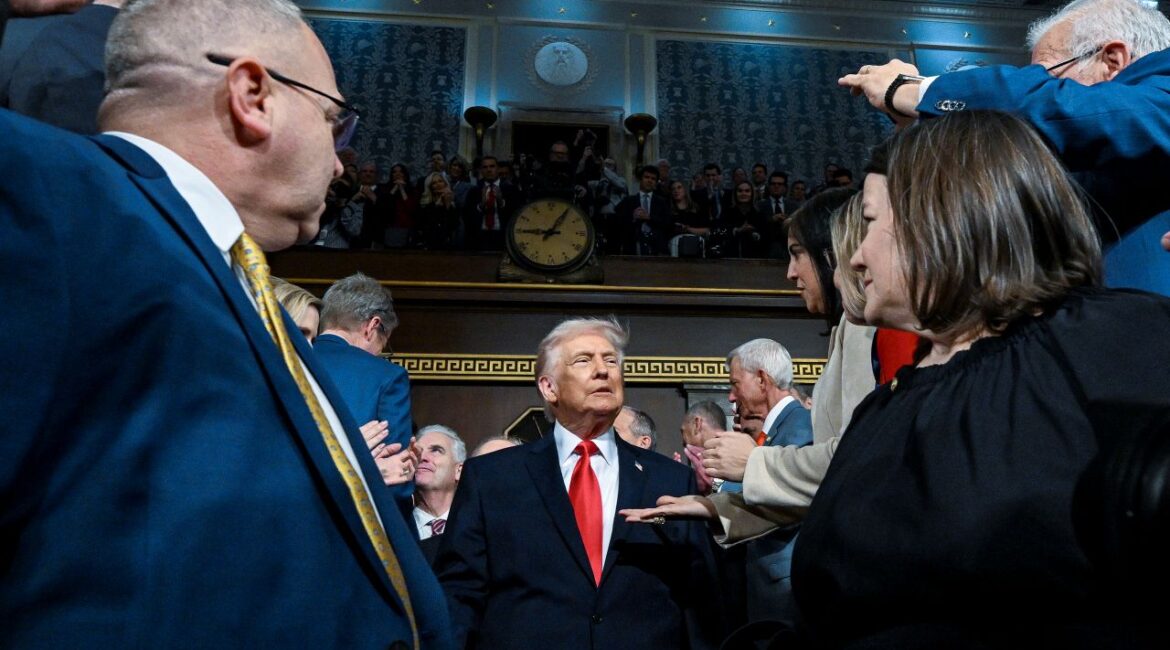 Image of President Donald Trump walking between Republican lawmakers