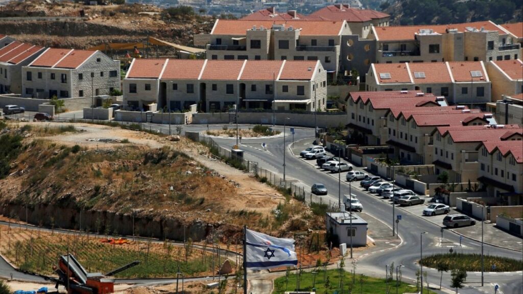 The Israeli national flag flutters as apartments are seen in the background in the Israeli settlement of Efrat in the Israeli-occupied West Bank August 18, 2020. (Reuters File)