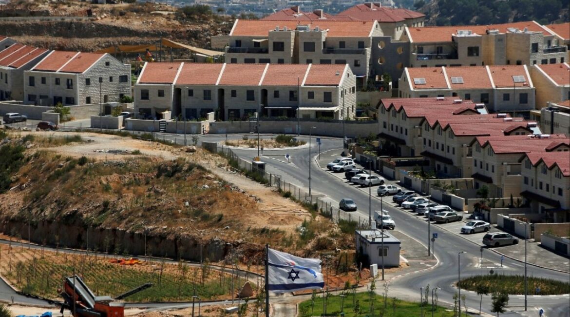 The Israeli national flag flutters as apartments are seen in the background in the Israeli settlement of Efrat in the Israeli-occupied West Bank August 18, 2020. (Reuters File)