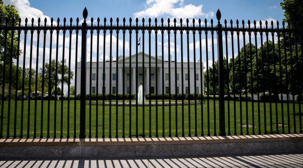 The White House is pictured behind a fence in Washington, U.S., April 25, 2021. (Reuters/Al Drago)