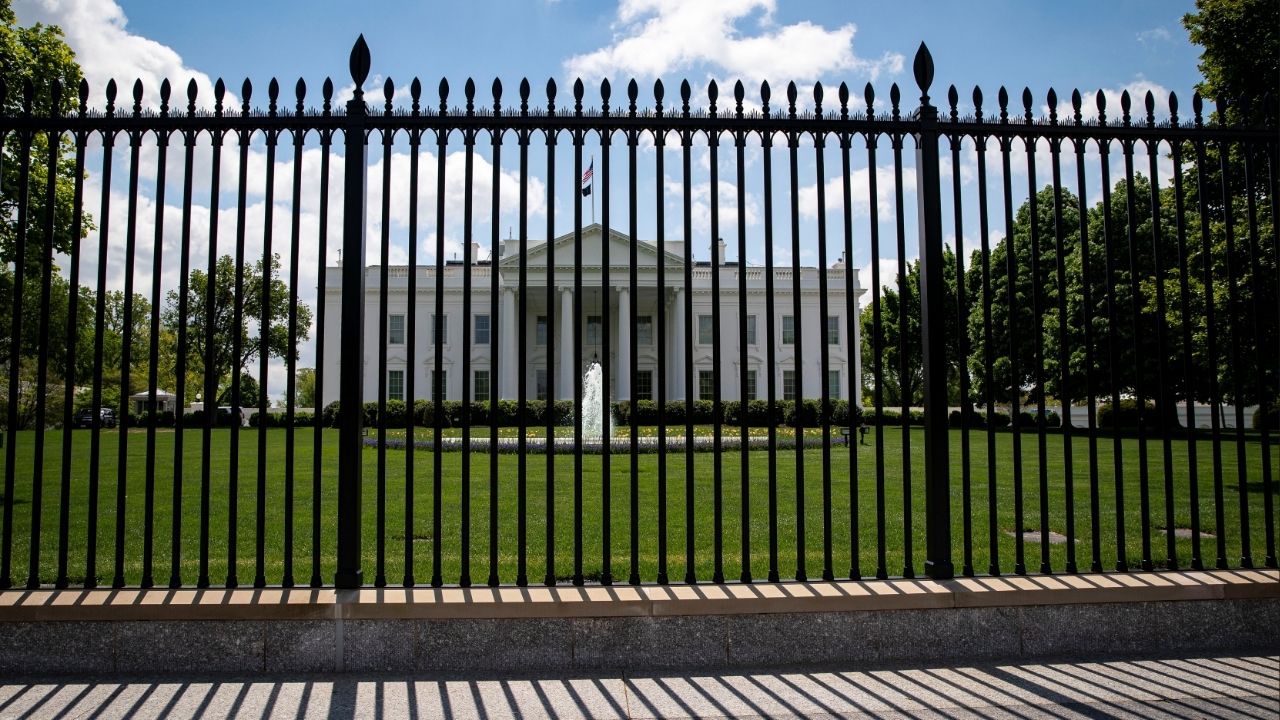 The White House is pictured behind a fence in Washington, U.S., April 25, 2021. (Reuters/Al Drago)