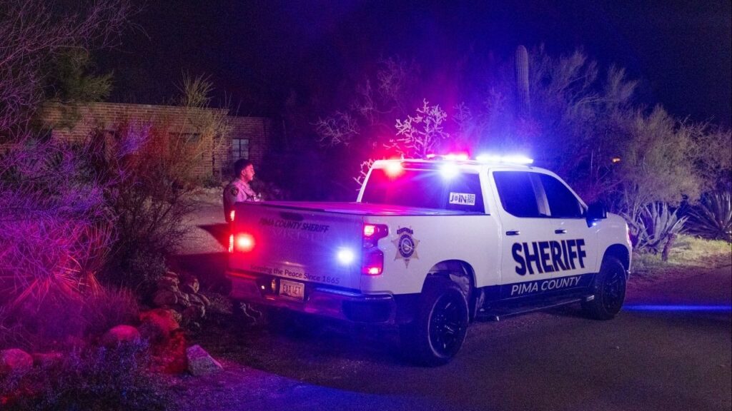 The home of Nancy Guthrie continues to be watched overnight in Tucson, Ariz., Feb. 10, 2026. New images and videos released on Tuesday showed a masked, armed person at Nancy Guthrie’s doorstep on the night she was abducted, the first significant break in the search for the 84-year-old mother of the “Today” show host Savannah Guthrie. (Cassidy Araiza/The New York Times)