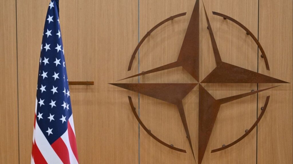This photo shows the logo of the North Atlantic Treaty Organization (NATO) and the US flag at NATO headquarters in Brussels, Belgium on February 17, 2025. (Nicolas Tucat/Pool via Reuters)