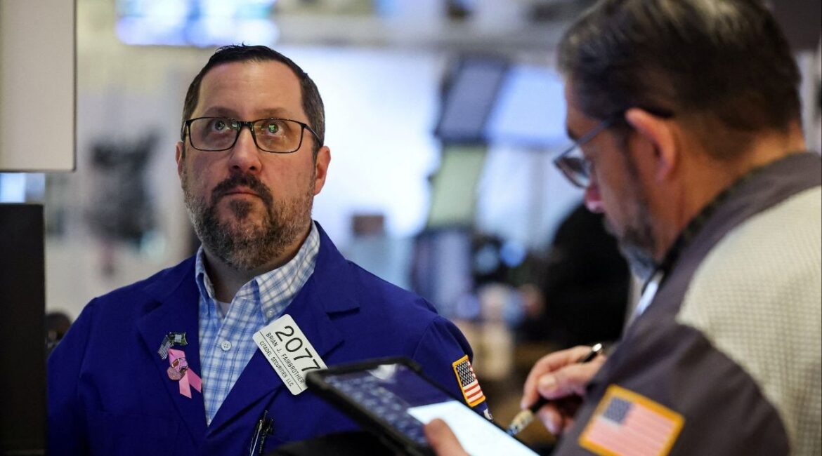 Traders work on the floor at the New York Stock Exchange (NYSE) in New York City, U.S., February 5, 2026. (Reuters/Brendan McDermid)